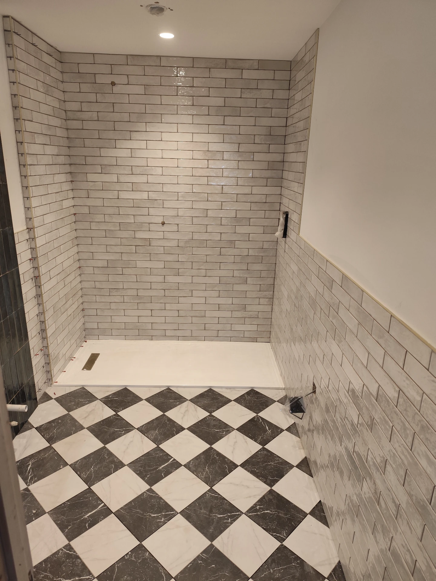 Black and white mosaic tile floor in a retail store lobby