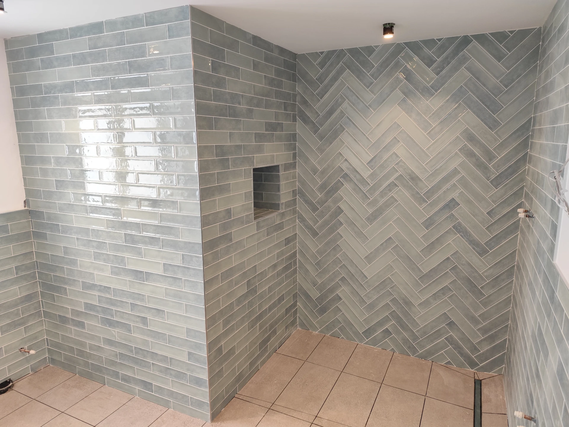 Fishbone herringbone tile pattern laid in a v-shape